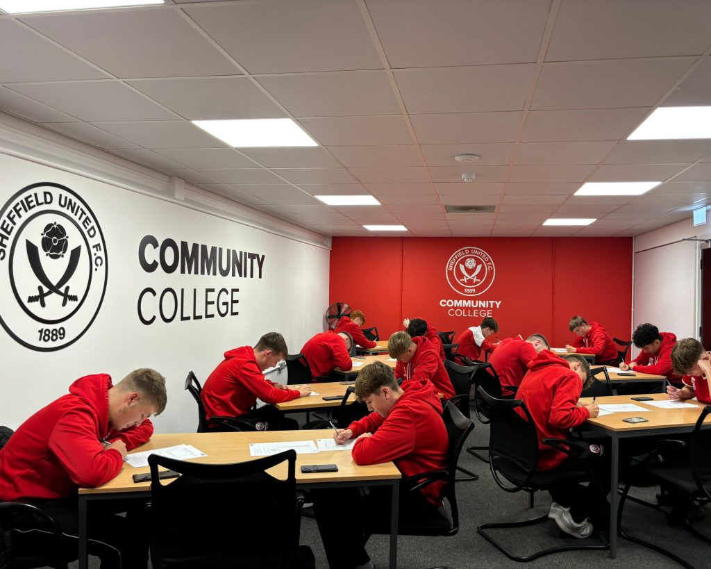 A class of students writing at their desks at Sheffield United Community College