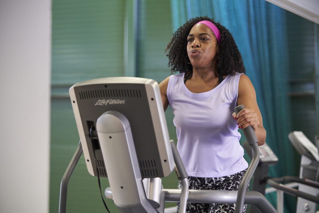 Woman exercising on crossfit maching