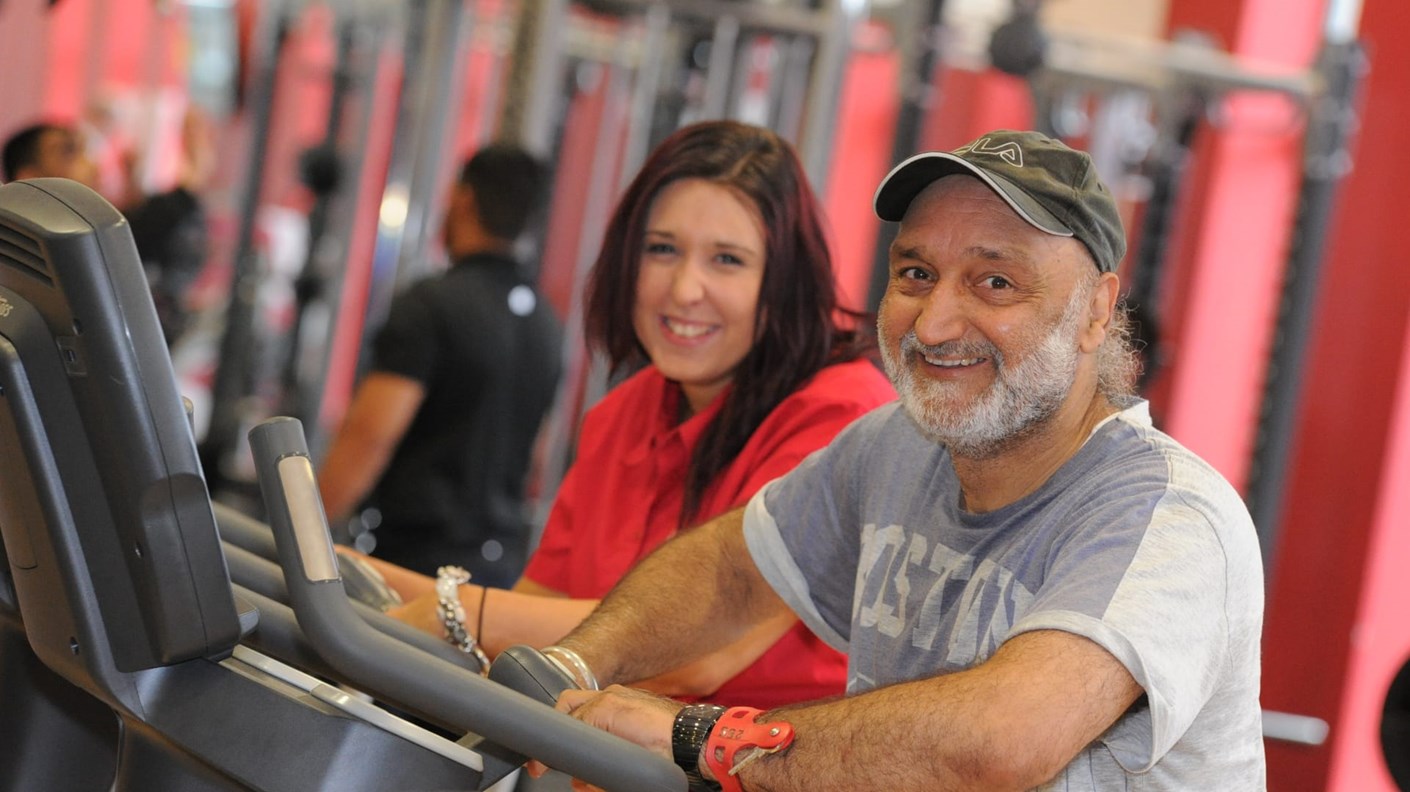 Happy people using gym equipment
