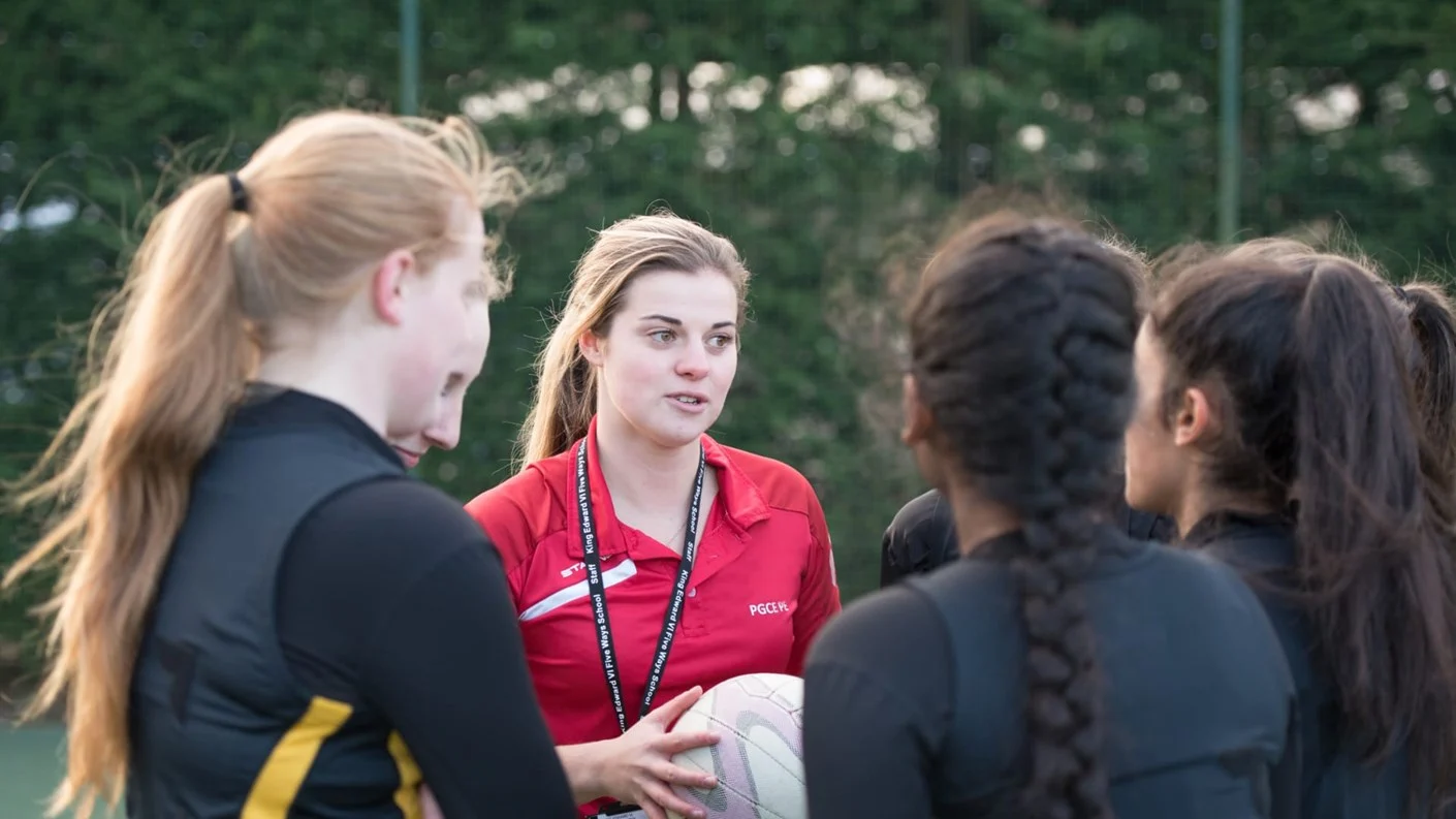 Higher Education tutor talking to students