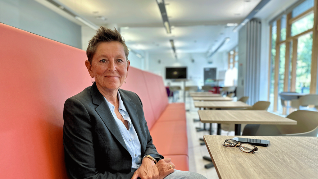 Tara Dillon sitting down in cafe looking at camera