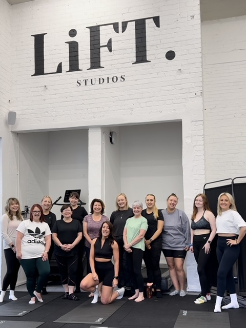 Group of women standing in exercise studio
