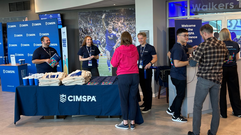 CIMSPA staff hold a stand and welcome delegates to the conference