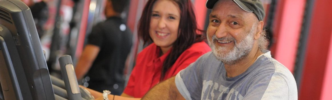 Happy people using gym equipment