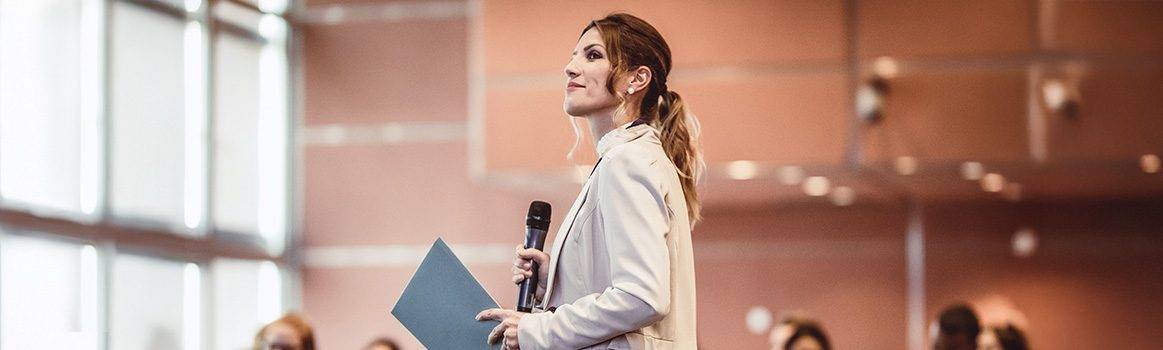 iStock-1039606566_Female speaker at a conference